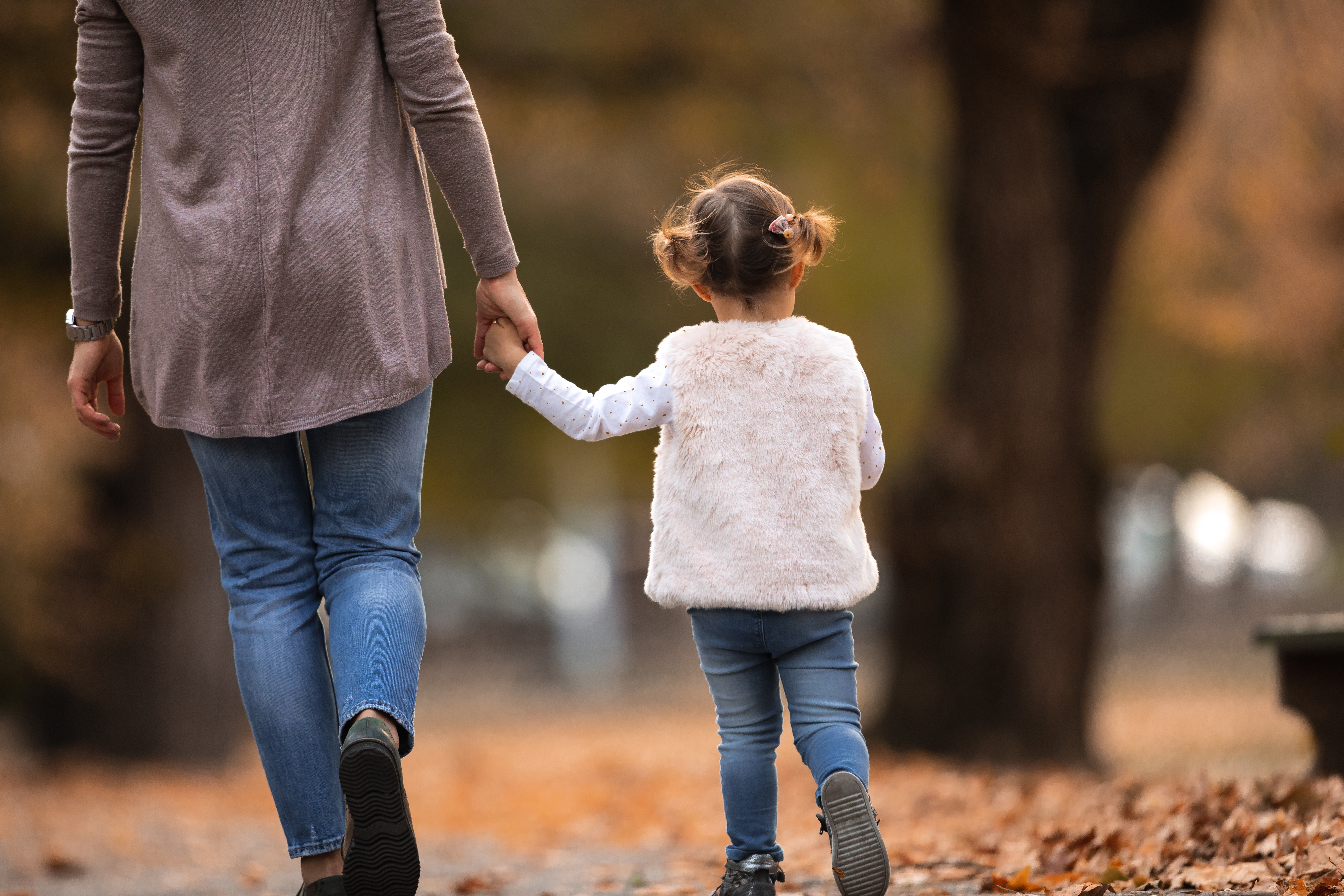 Mother and young child walking hand in hand